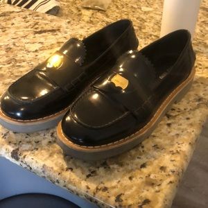 Gorgeous leather Miu Miu leather, black loafers with Miu Miu branded coin.